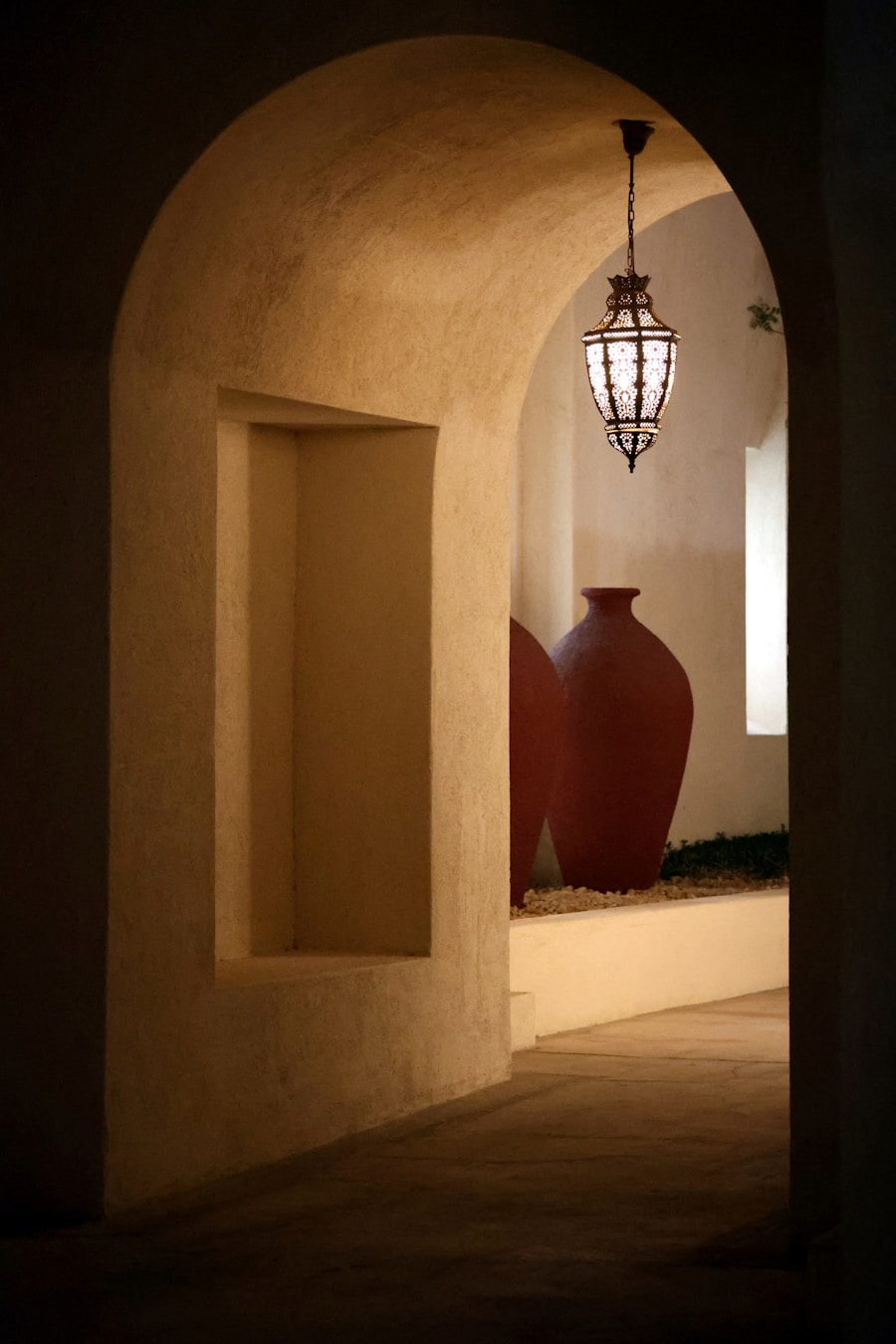Arched plaster hallway with a lantern and terracotta urns, Spanish revival style