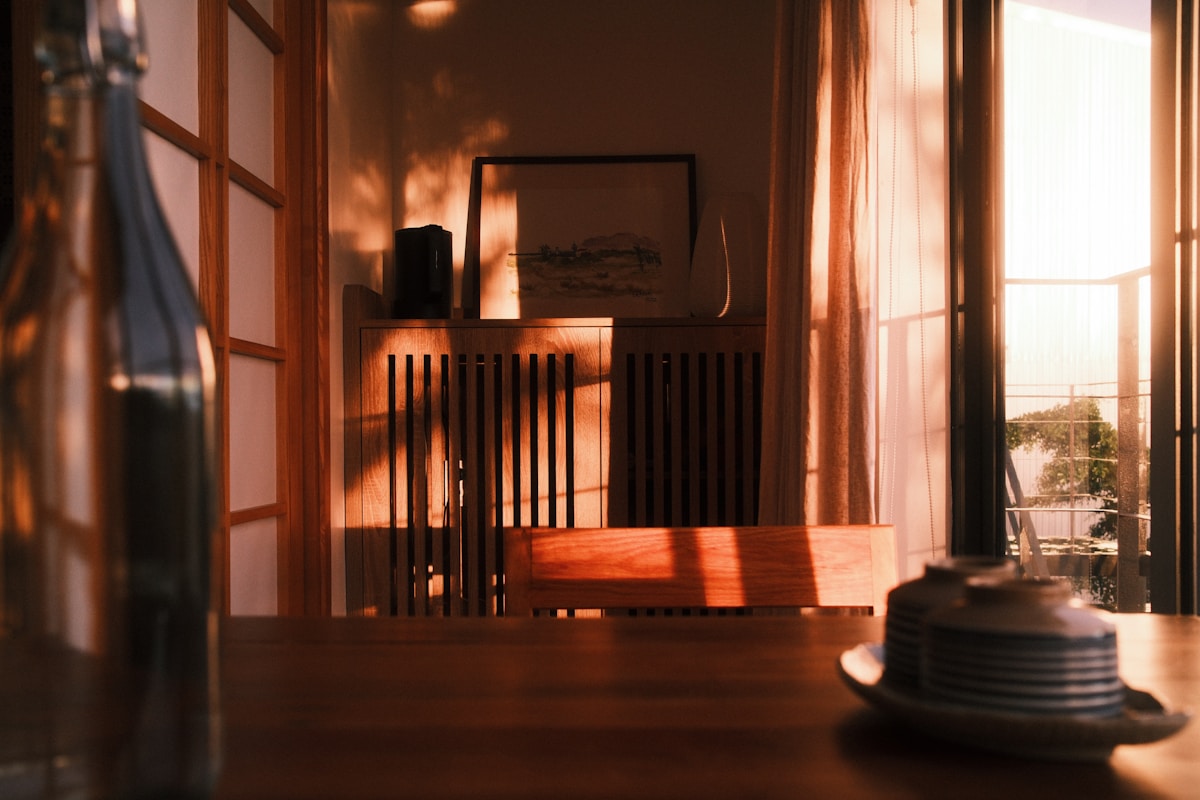 Late afternoon light falling through a doorway onto a wooden table