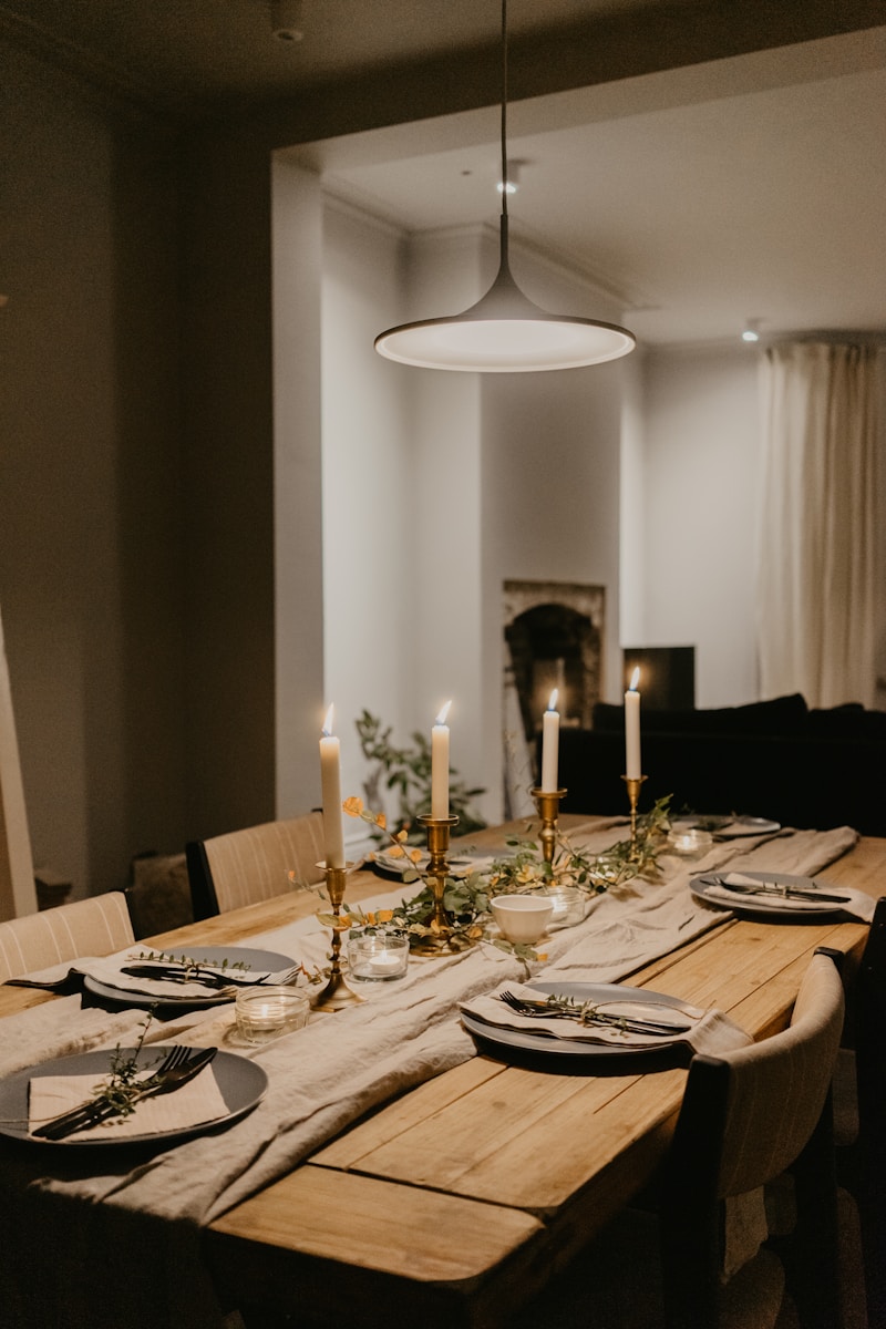 Candlelit dining table set with linen